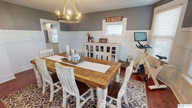 dining area featuring dark hardwood / wood-style flooring and a chandelier