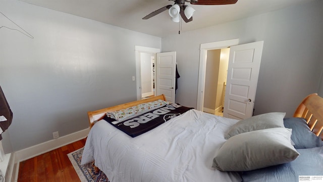 bedroom with dark wood-type flooring and ceiling fan