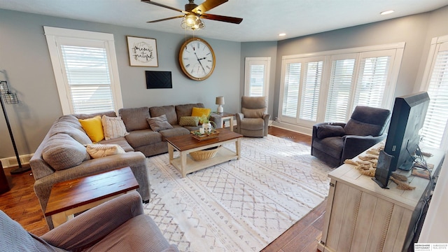 living room with hardwood / wood-style floors and ceiling fan