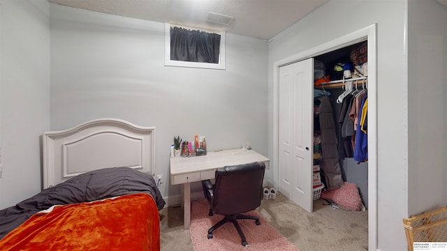 bedroom featuring light carpet and a closet