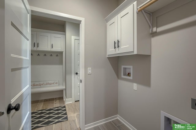 laundry room featuring cabinets, washer hookup, hookup for an electric dryer, and light hardwood / wood-style floors