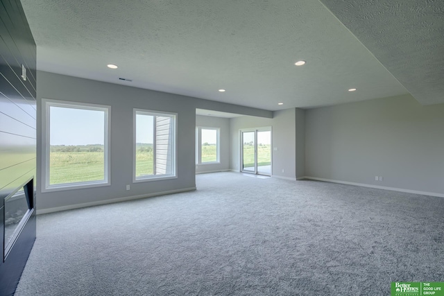 spare room with carpet floors and a textured ceiling