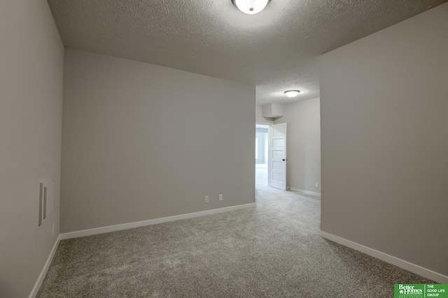 unfurnished room featuring carpet floors and a textured ceiling