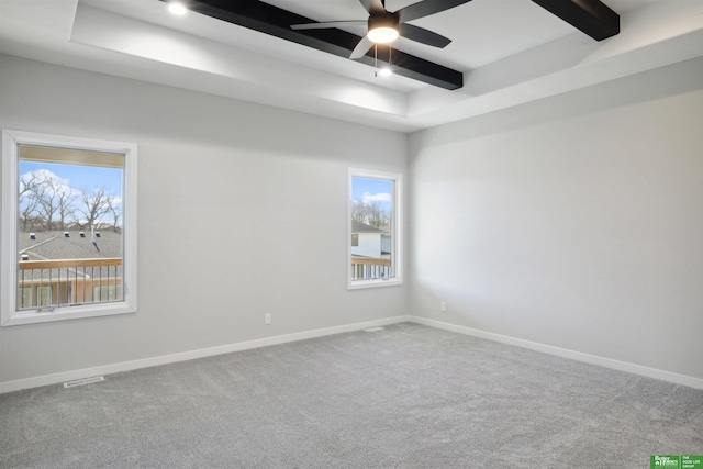 empty room with visible vents, baseboards, ceiling fan, beamed ceiling, and carpet floors