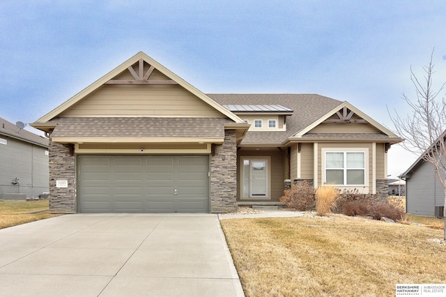 craftsman-style home featuring a garage and a front lawn