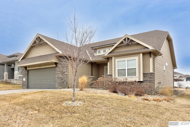 craftsman house with a garage and a front yard