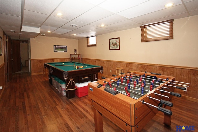 game room with wainscoting, wood finished floors, a paneled ceiling, and wooden walls