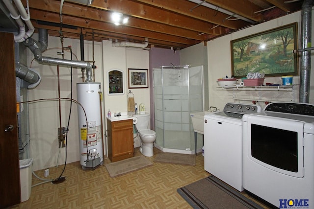 washroom with laundry area, gas water heater, and washing machine and clothes dryer