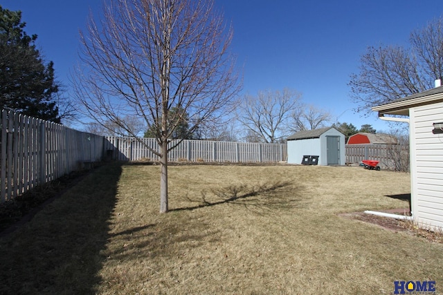 view of yard with a storage shed, an outbuilding, and a fenced backyard