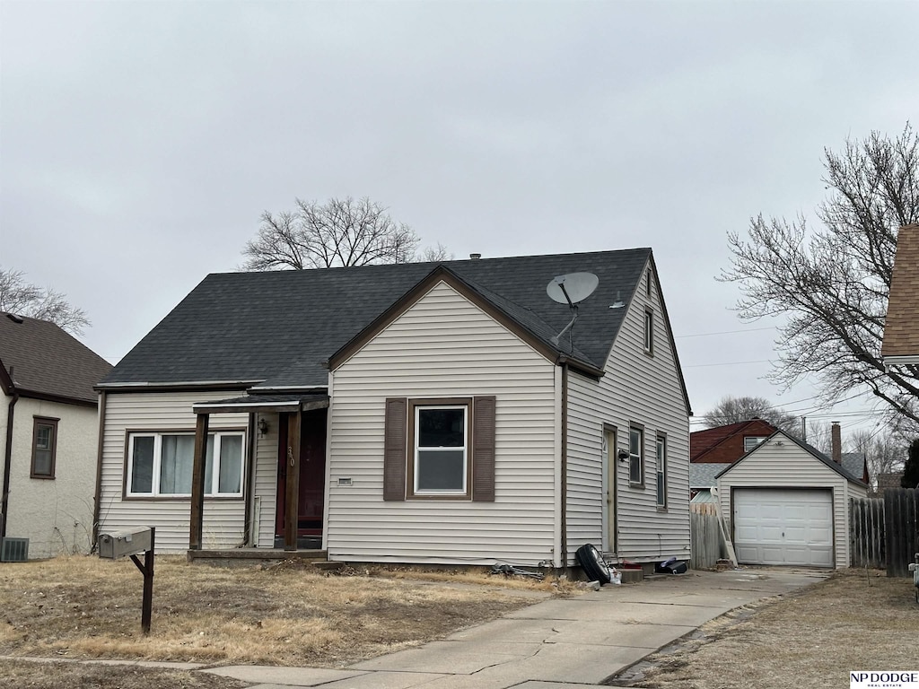 view of front of property featuring a garage and an outdoor structure