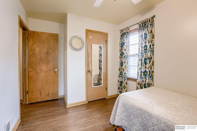 bedroom with wood-type flooring and ceiling fan