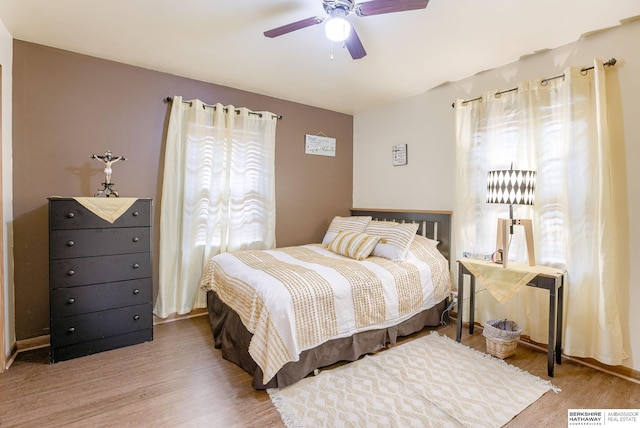 bedroom with hardwood / wood-style floors and ceiling fan