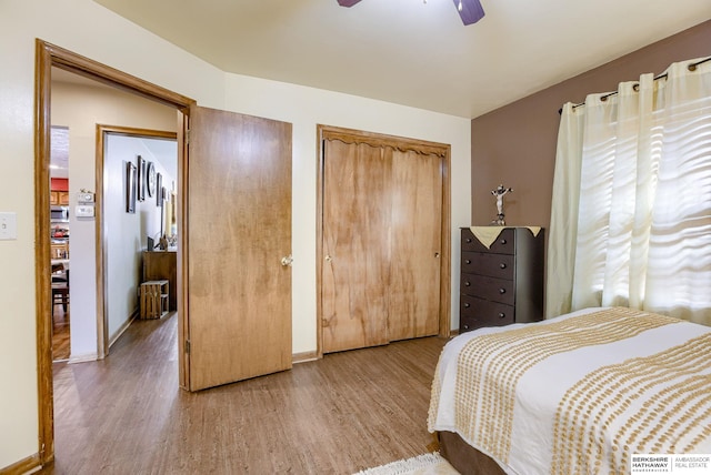 bedroom with wood-type flooring and ceiling fan