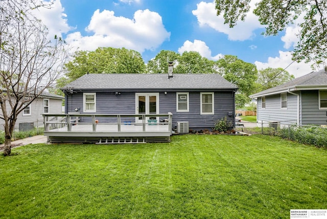 back of property featuring a wooden deck, central air condition unit, and a lawn