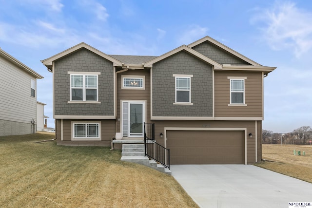 view of front facade with a garage and a front lawn