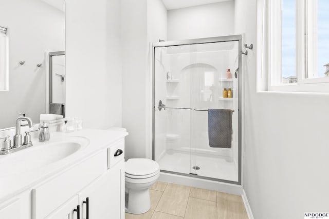 bathroom with toilet, vanity, and walk in shower