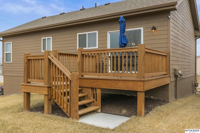 back of house with a wooden deck and a lawn