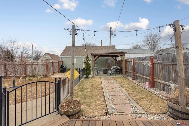 wooden terrace featuring a yard, a gazebo, and a patio area