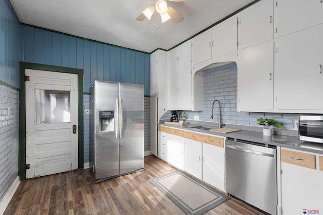 kitchen featuring sink, appliances with stainless steel finishes, dark hardwood / wood-style floors, ceiling fan, and white cabinets