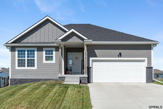 view of front of property featuring a garage and a front lawn