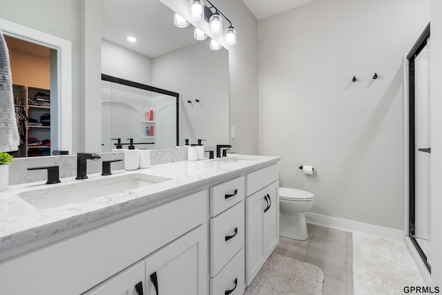 bathroom featuring walk in shower, vanity, toilet, and tile patterned flooring