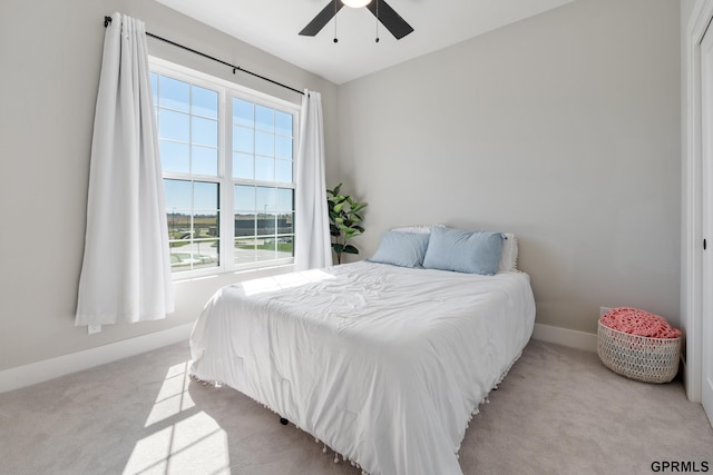 bedroom with ceiling fan and light carpet