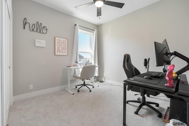 office space with light carpet and ceiling fan