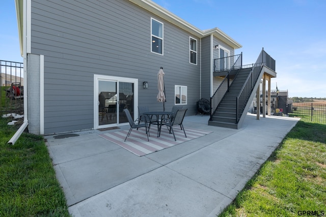 back of property with a yard and a patio area