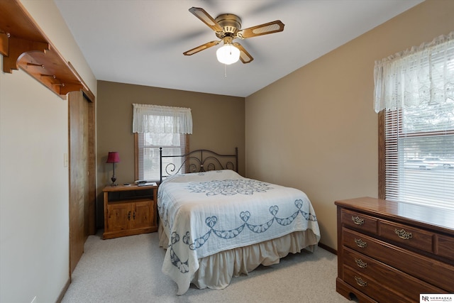 bedroom featuring light colored carpet and ceiling fan