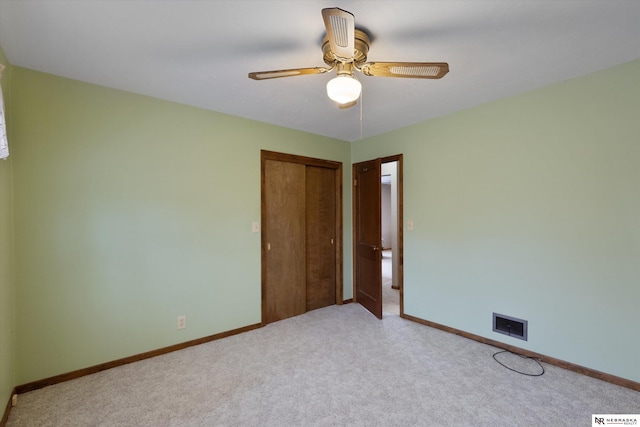 spare room with light carpet and ceiling fan