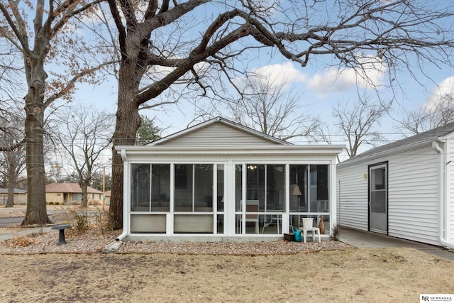 back of property featuring a sunroom