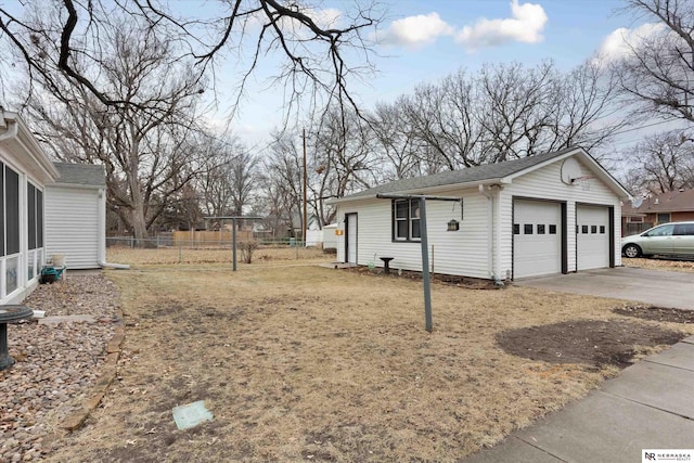 view of side of home with a garage and an outbuilding