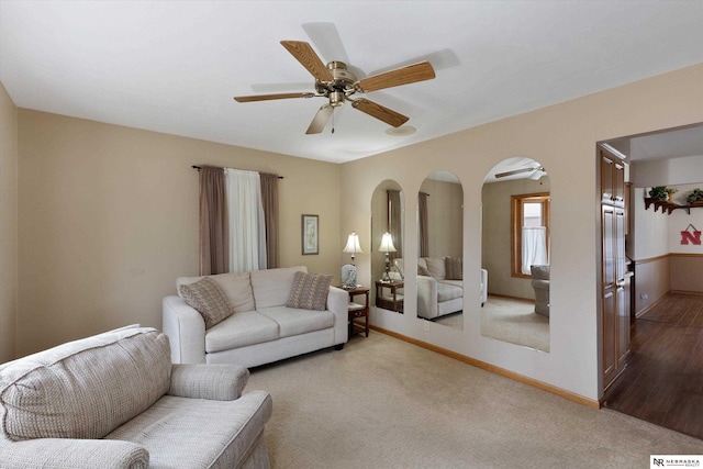 living room with light colored carpet and ceiling fan