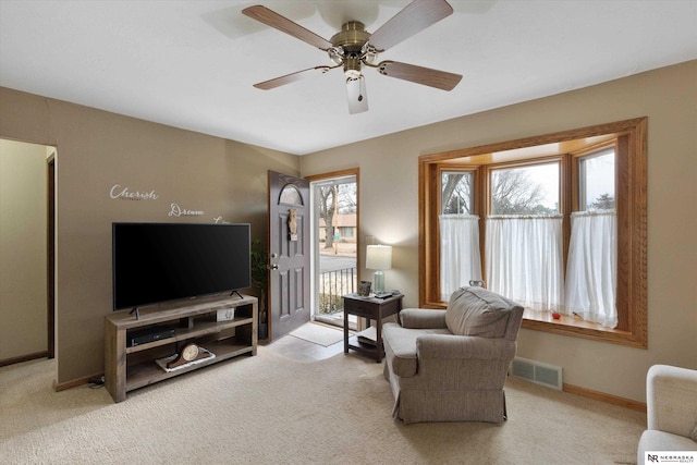 living room featuring light colored carpet and ceiling fan