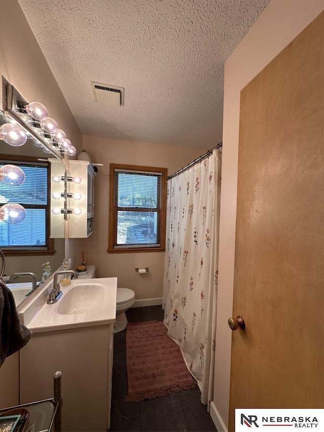 bathroom with tile patterned flooring, a shower with shower curtain, vanity, a textured ceiling, and toilet