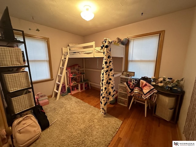 bedroom with dark hardwood / wood-style floors