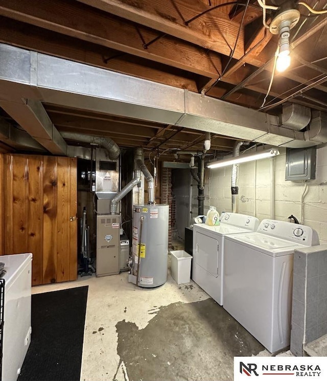 basement with washer and dryer, electric panel, and water heater