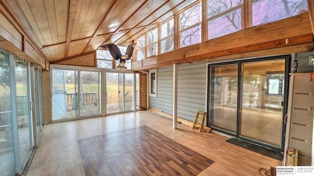 unfurnished sunroom featuring wood ceiling and vaulted ceiling