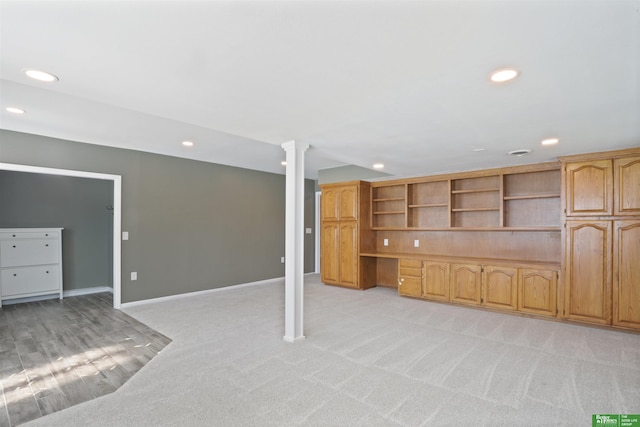 basement featuring light colored carpet