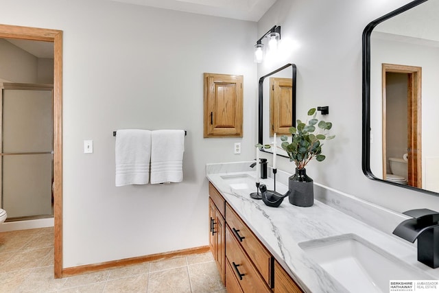 bathroom featuring vanity, tile patterned flooring, a shower with shower door, and toilet