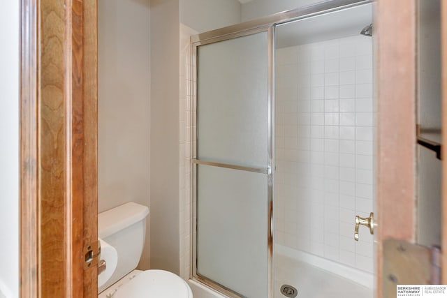 bathroom featuring toilet and walk in shower