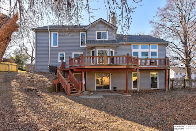 rear view of house featuring central AC unit and a deck