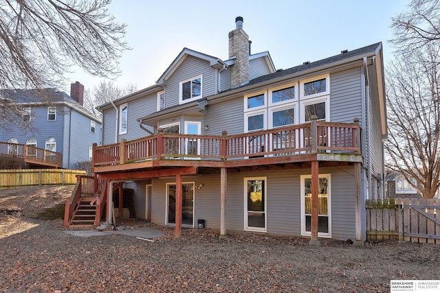 rear view of property featuring a wooden deck