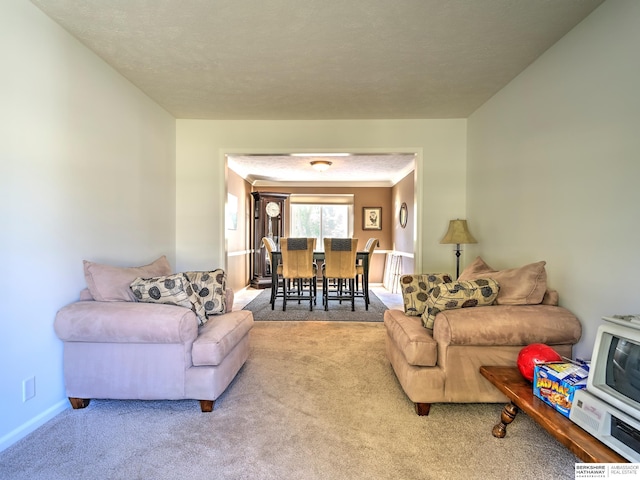 living room featuring light carpet and a textured ceiling