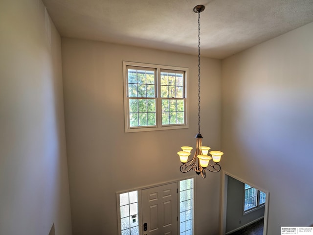 room details with a notable chandelier and a textured ceiling