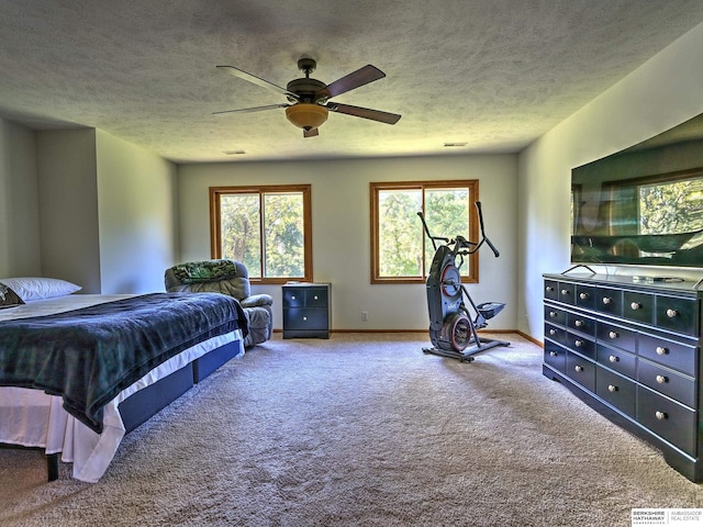 bedroom featuring ceiling fan, a textured ceiling, and carpet flooring