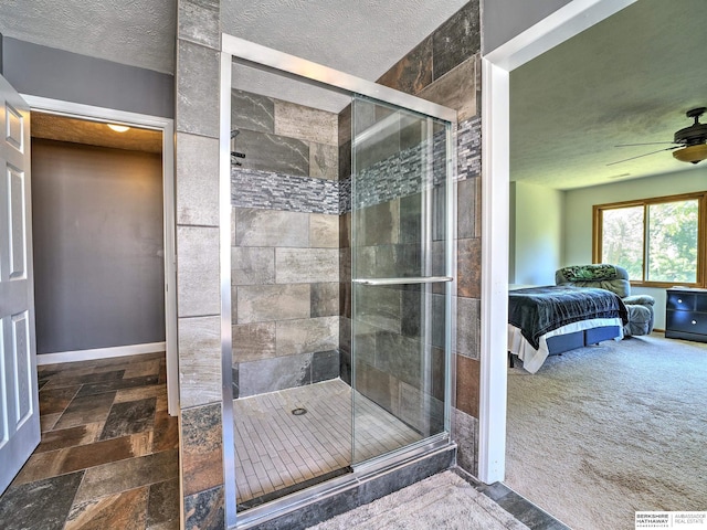 bathroom featuring an enclosed shower, ceiling fan, and a textured ceiling