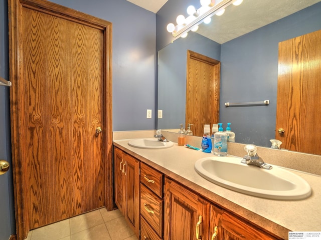 bathroom with tile patterned flooring and vanity