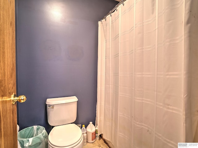 bathroom featuring toilet and tile patterned flooring