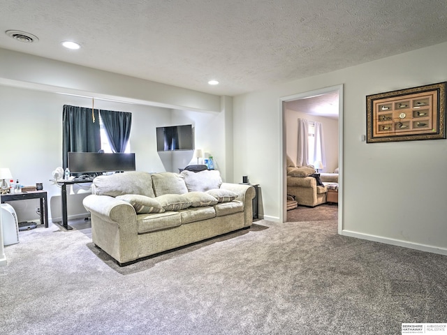 carpeted living room with a textured ceiling